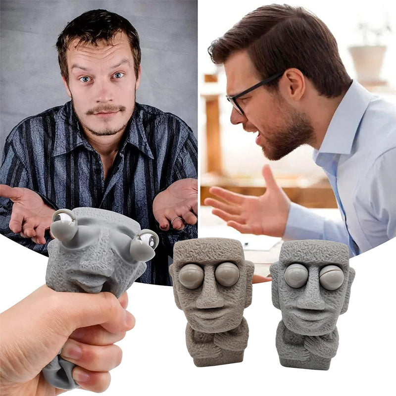 Moai LED stressleksak med utstickande ögon, grå/brun färg, kompakt design, perfekt för stressavlastning och dekoration.