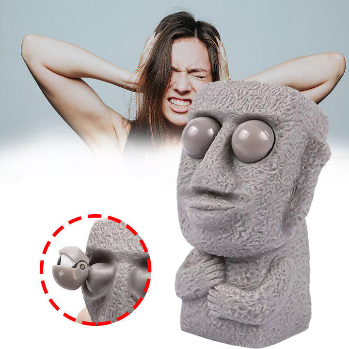 Moai LED stressleksak med utstickande ögon, grå/brun färg, kompakt design, perfekt för stressavlastning och dekoration.
