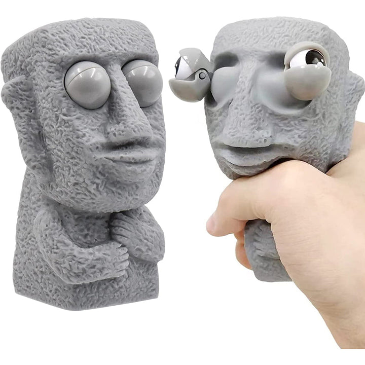 Moai LED stressleksak med utstickande ögon, grå/brun färg, kompakt design, perfekt för stressavlastning och dekoration.