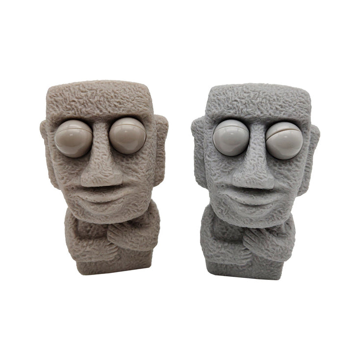 Moai LED stressleksak med utstickande ögon, grå/brun färg, kompakt design, perfekt för stressavlastning och dekoration.