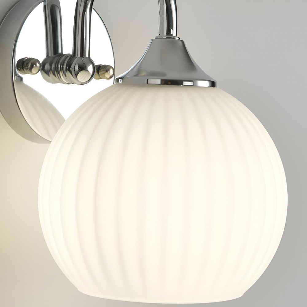 Vardagsrumsbelysning: klotformad LED-vägglampa i randigt glas, modern stil.