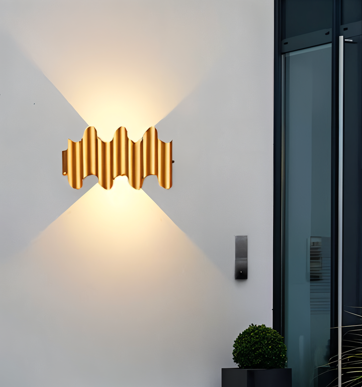 Guld- och svart vägglampa, modern design. LED-belysning som skapar effektfullt upp/ner-sken.