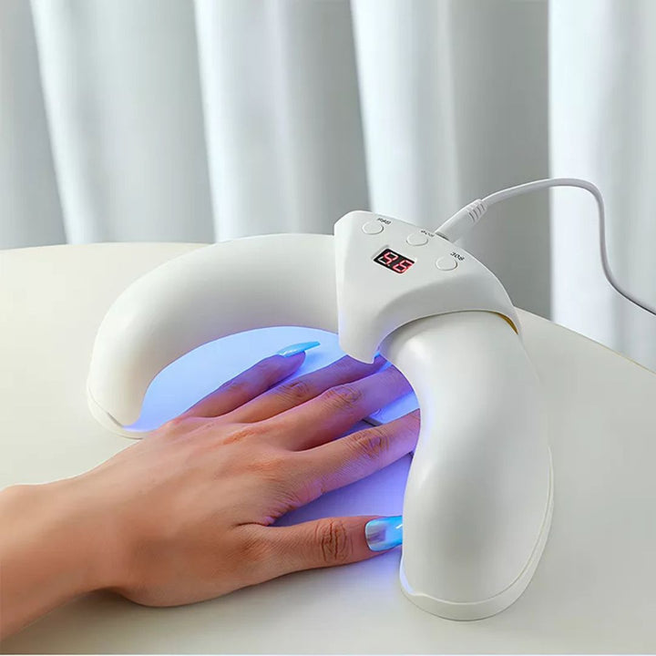 Kompakt nagelvårdsapparat med LED-ljus för enkel fotvård hemma, rött och blått ljus.