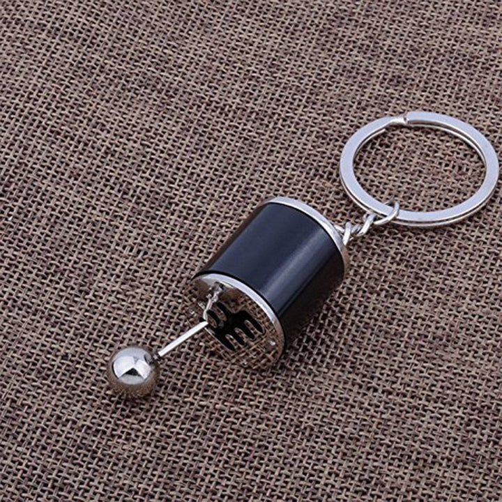 Nyckelring med metallväxelspak, realistisk design med sex växlar, perfekt för bilentusiaster.
