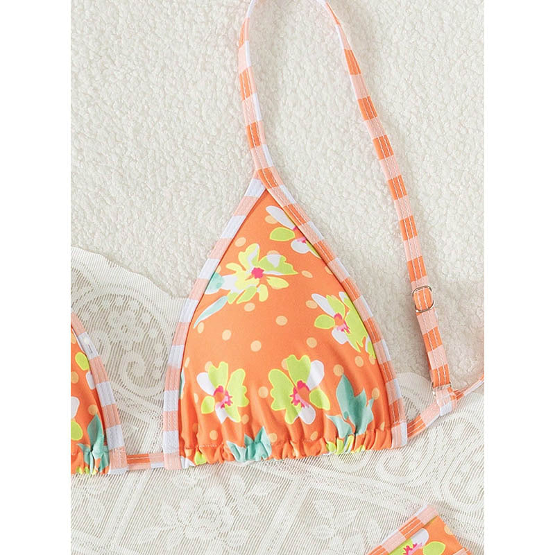 Trendig orange dambikini med vackert blommönster. Bekväma badkläder med justerbara band för sommarstil.