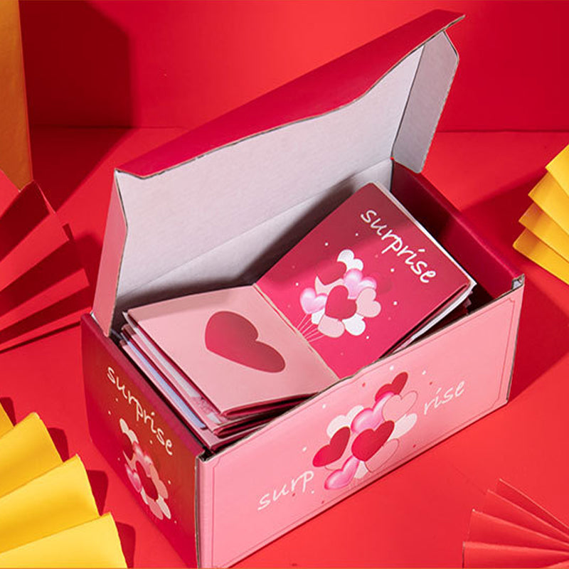 Överraskningspresentask med popup-effekt i glada färger som rosa och gul, perfekt för födelsedagar och fester.
