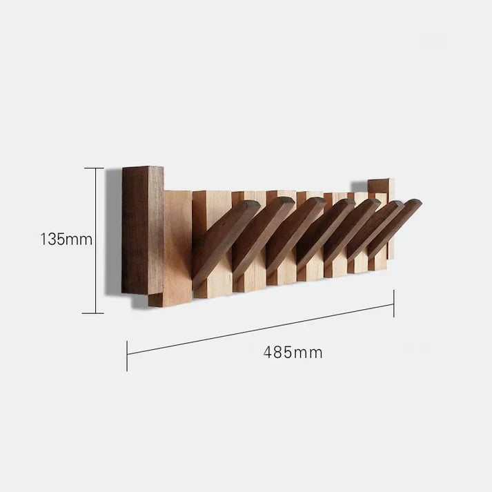 Minimalistisk pianoväggkrok i svart design för smart och platsbesparande förvaring av kläder.