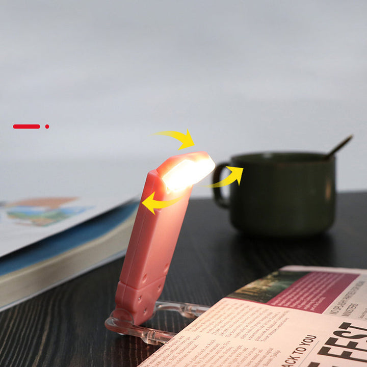 "Portabel justerbar uppladdningsbar LED-boklampa i rosa, svart, grön, blå eller vit med flexibel hållare och USB-laddning."