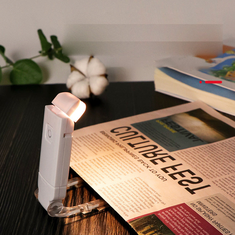 "Portabel justerbar uppladdningsbar LED-boklampa i rosa, svart, grön, blå eller vit med flexibel hållare och USB-laddning."