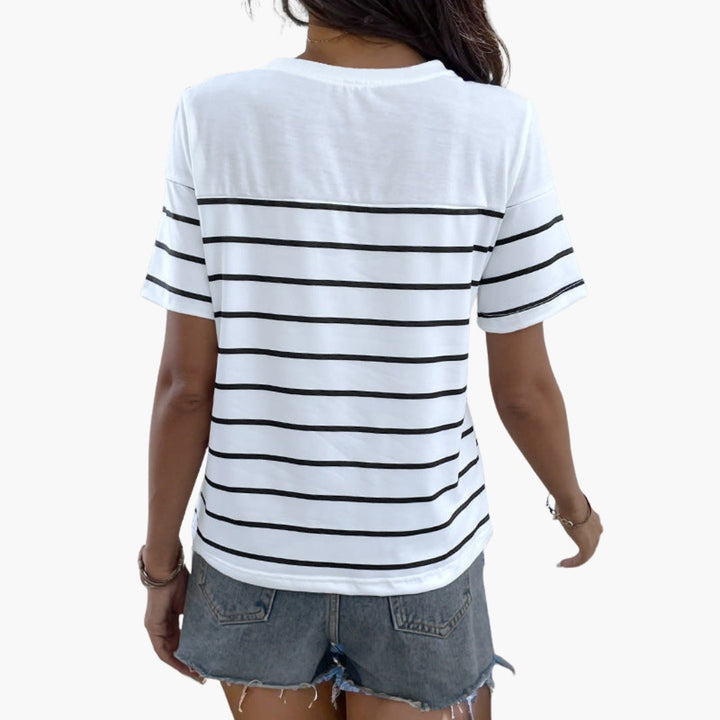 Elegant randig dam t-shirt med axelknappar. Kortärmad svartvit topp, idealisk för bekvämt sommar- och vardagsbruk.
