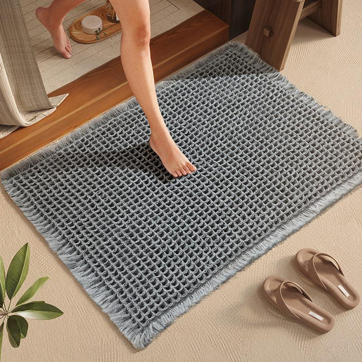 Texturerad absorberande entrématta i grå färg på ljust golv