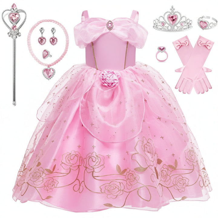 Detaljerad bild på rosa prinsessklänning med rosett och accessoarer
