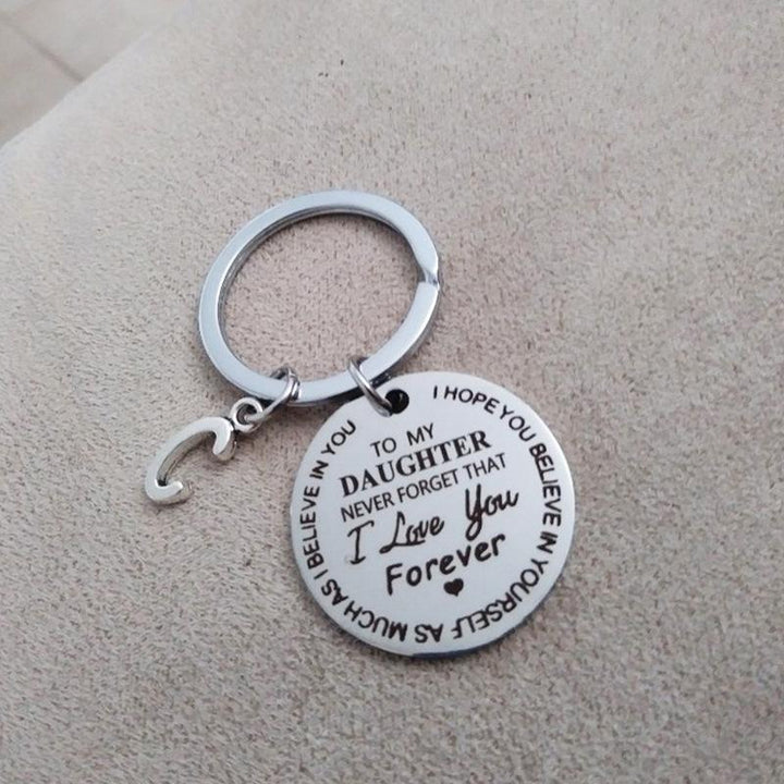 "Rund nyckelring för son/dotter i rostfritt stål, symboliserar kärlek och omsorg, perfekt accessoar och meningsfull gåva."