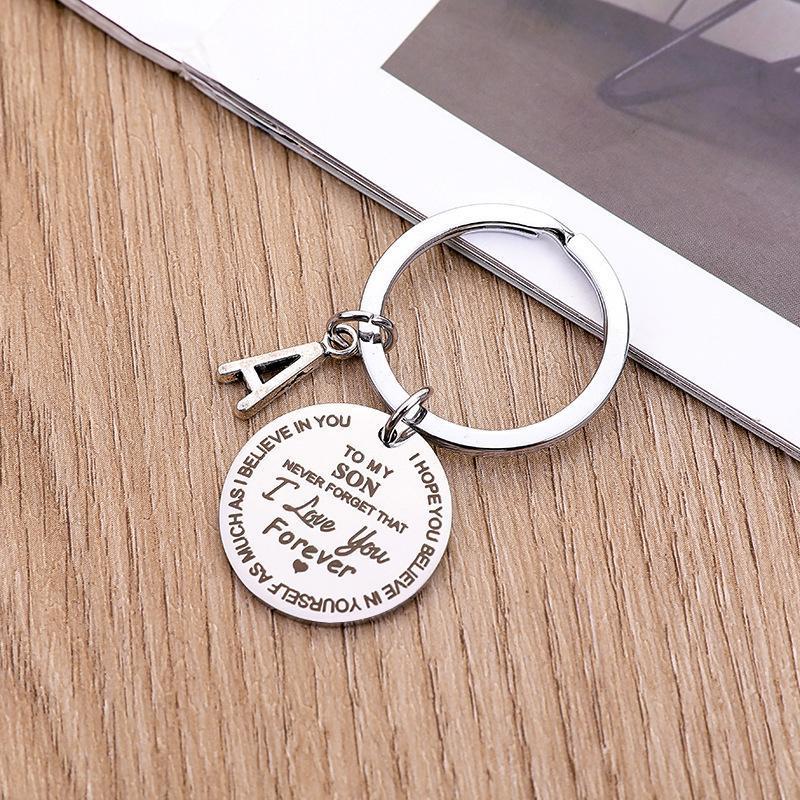 "Rund nyckelring för son/dotter i rostfritt stål, symboliserar kärlek och omsorg, perfekt accessoar och meningsfull gåva."