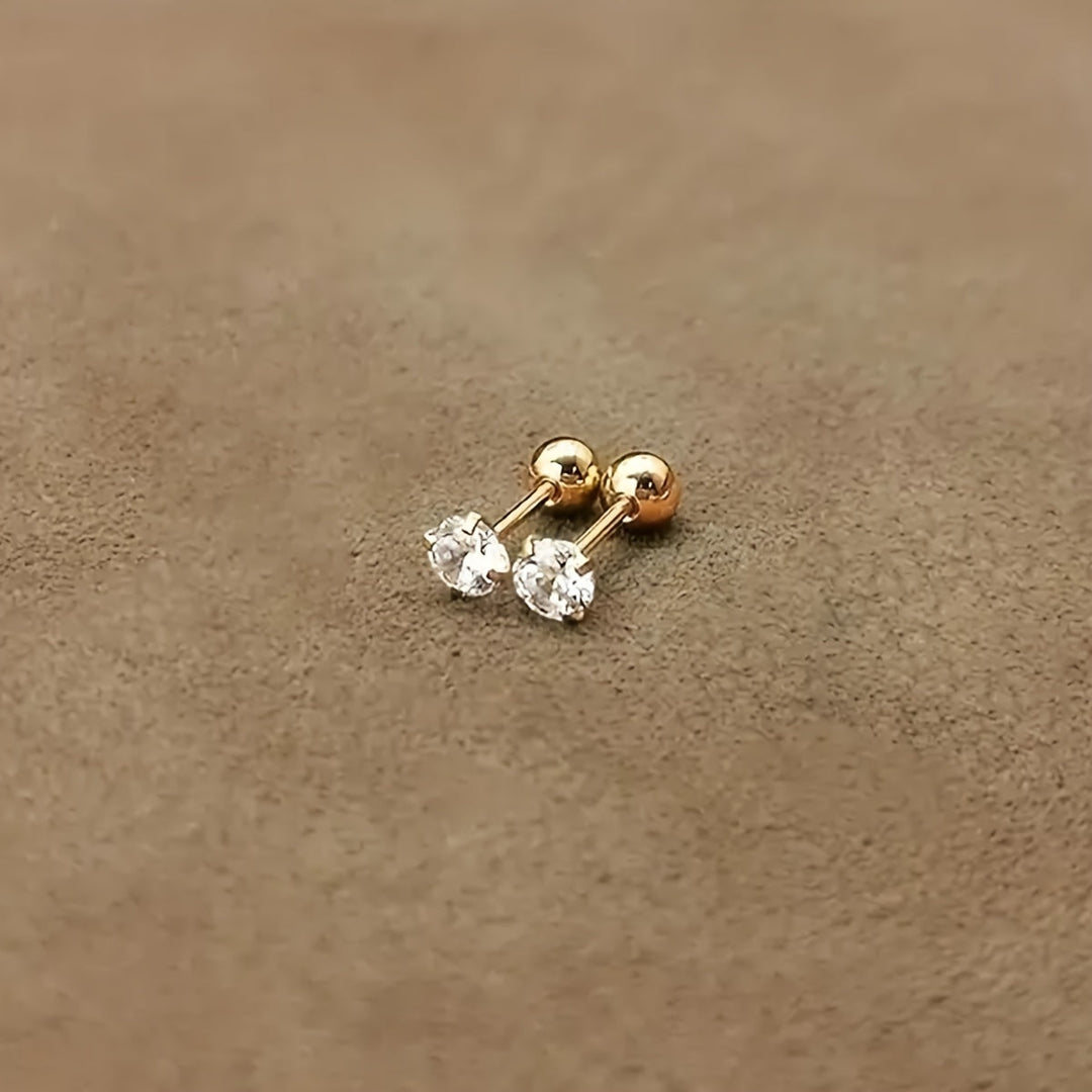 Lätta runda unisex örhängen i titanstål med en enkel zirkonia sten. Glänsande klassiska accessoarer.