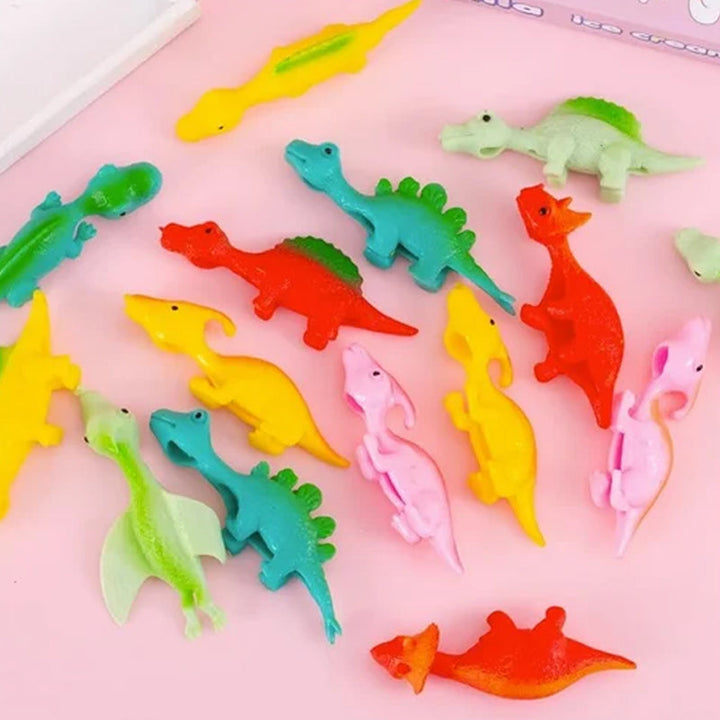 "Set om 10 fingerleksaker med dinosaurieslungor i färgglada mönster, perfekt för barn att leka och lära sig om dinosaurier."