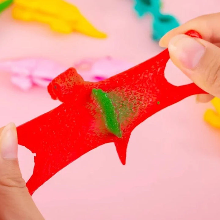"Set om 10 fingerleksaker med dinosaurieslungor i färgglada mönster, perfekt för barn att leka och lära sig om dinosaurier."