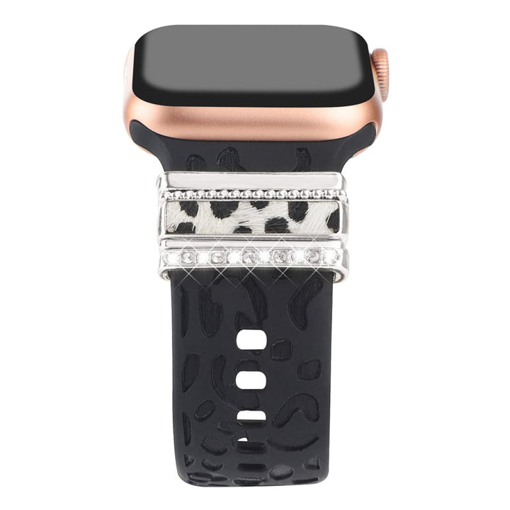 Smartklockband med dekorativa metallringar i gyllene leopardmönster och roséguldstjärnor, elegant stilaccessoar.