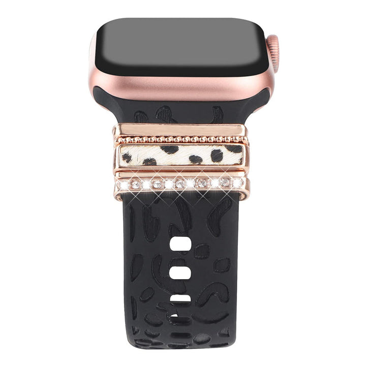Smartklockband med dekorativa metallringar i gyllene leopardmönster och roséguldstjärnor, elegant stilaccessoar.