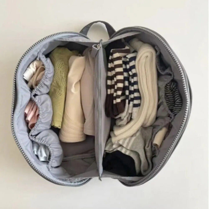 Smidig Packify necessär för effektiv packning. Reseväska för smink och hygien i grått/rosa.