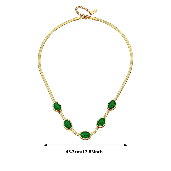 "Smycke i titanstål för kvinnor, smaragdberlock: elegant halsband och armband i grönt för stil och sofistikation."