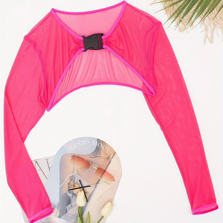 Trendig cropped långärmad topp för dam. Elegant spänne detalj, idealisk för mode och fritid.