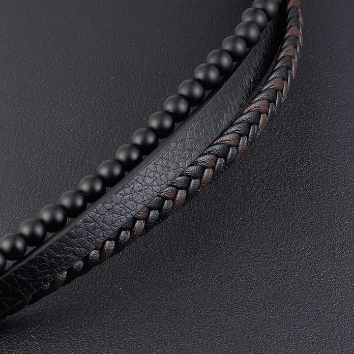 Svart flätat armband med hematitpärlor, stresslindrande och elegant accessoar för moderna män.