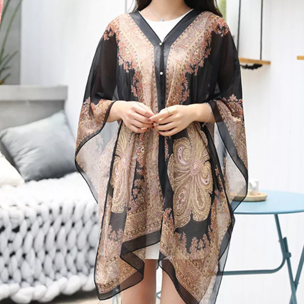 Mira damponcho-sjal i svart, elegant och mångsidig för höst. Lyxig one size modeaccessoar som värmer.