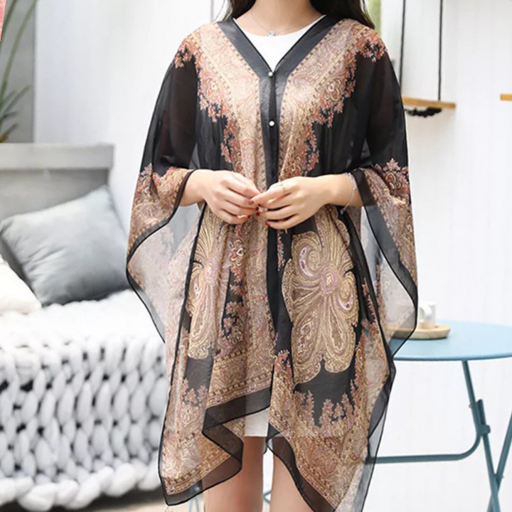 Mira damponcho-sjal i svart, elegant och mångsidig för höst. Lyxig one size modeaccessoar som värmer.