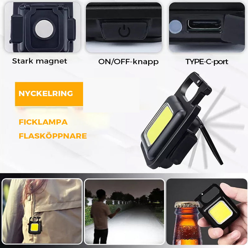 "Svart multifunktionell nyckelring nödljus med kompakt design och 4 ljuslägen, perfekt för utomhusaktiviteter."