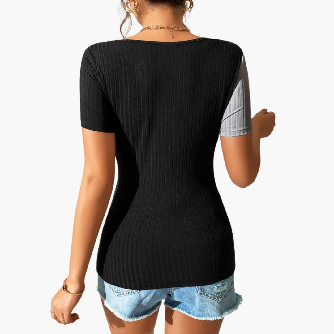 Modern svart dam t-shirt med asymmetrisk halsringning, kortärmad och med stilren bröstutskärning. Ribbad vardagstopp.