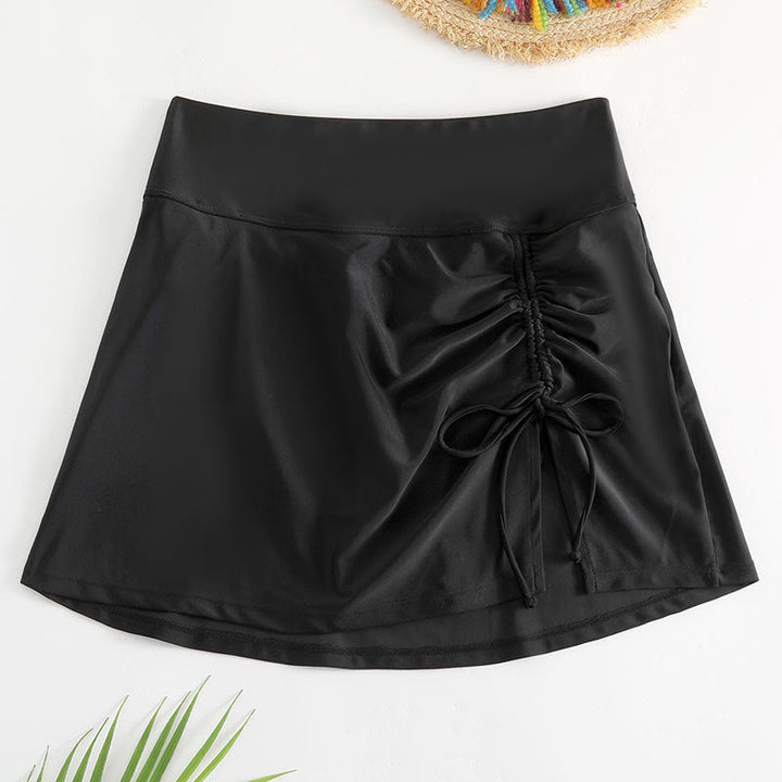Modern svart sportig kjol för kvinnor, knälång med unik justerbar cut-out design. Aktivkläder.