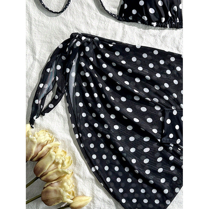Elegant, svart cover-up med prickmönster för dam. Lätt och luftig att bära över din bikini på stranden.