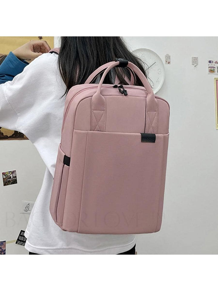 Stilren korallrosa vattentät ryggsäck med laptopskydd, perfekt för resor och dagliga äventyr.