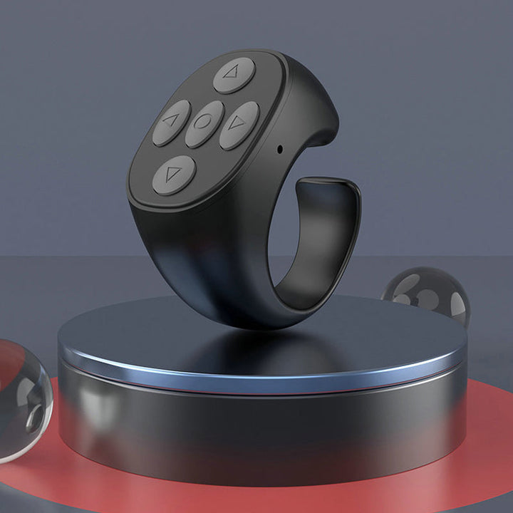 "Trådlös Bluetooth-ringfjärrkontroll för mobil, ergonomisk design, kompakt storlek, finns i svart, rosa, vit."