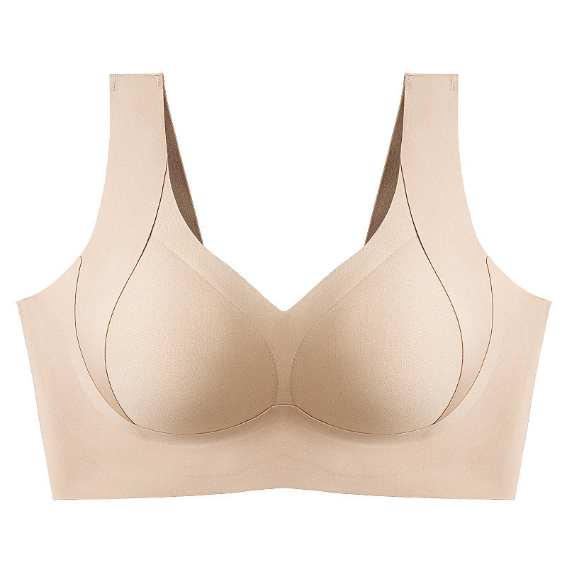 Skarvlös dam-BH i beige med sidostöd och fast stoppning för ökat stöd, smidig design för en slät silhuett.
