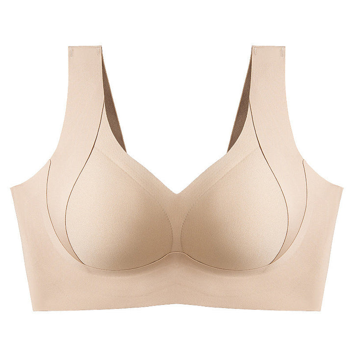 Skarvlös dam-BH i beige med sidostöd och fast stoppning för ökat stöd, smidig design för en slät silhuett.