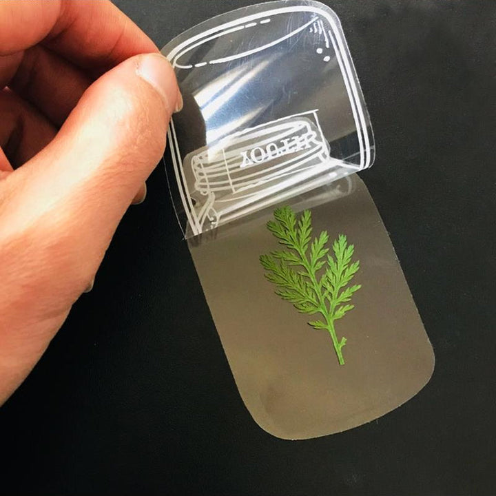 "Transparent bokmärke med torkade blommor, handgjord, elegant design, tunt och hållbart; perfekt för bokälskare."