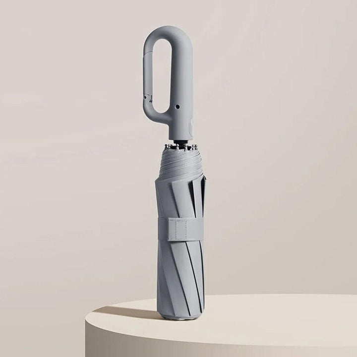Grått kompakt paraply med ergonomiskt handtag