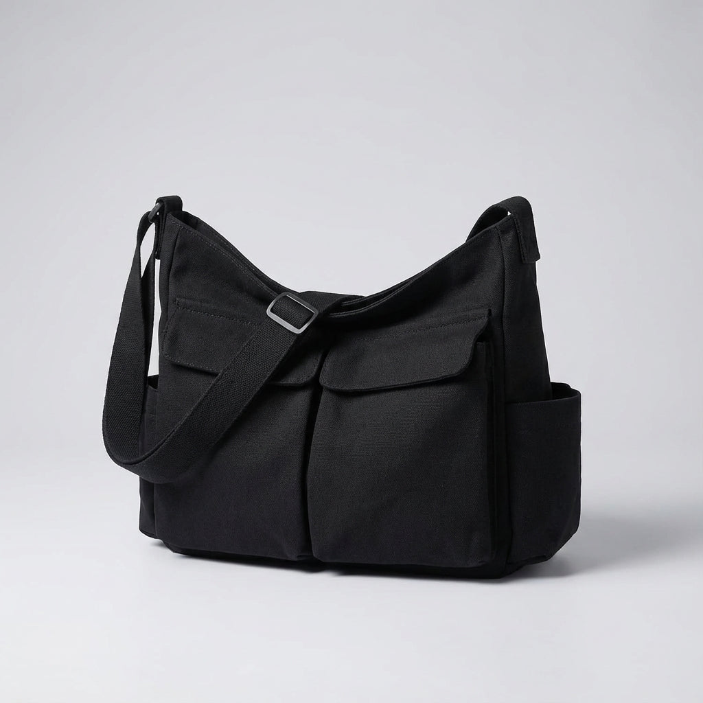 Grön canvas messengerbag, unisex modell med justerbar axelrem och rymliga fack för organiserad förvaring.