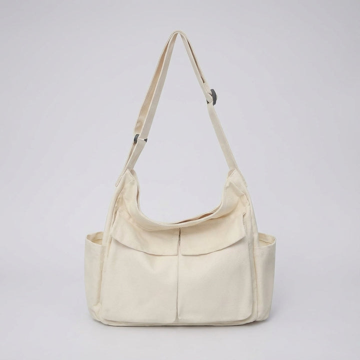 Praktisk dagsväska i canvas, justerbar crossbody-rem, unisex, perfekt för att bära nödvändigheter smidigt.