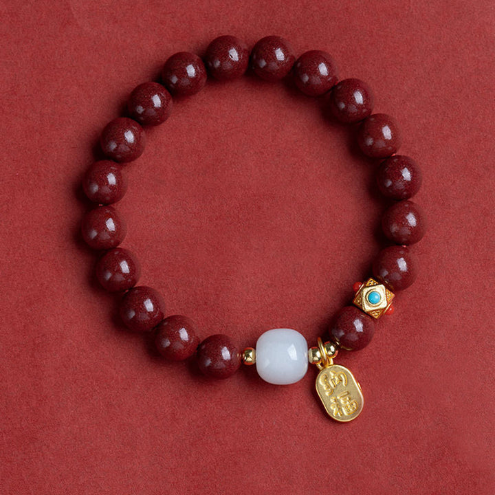Unisex cinnoberarmband i röd jaspis med släta pärlor, eleganta och jordnära smycken för vardagsbruk.