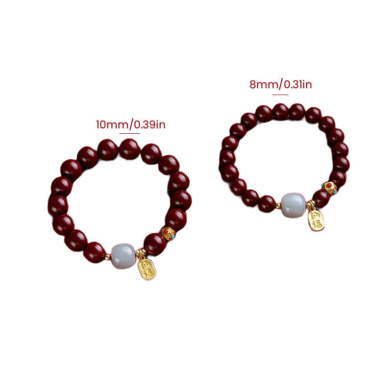 Unisex cinnoberarmband i röd jaspis med släta pärlor, eleganta och jordnära smycken för vardagsbruk.