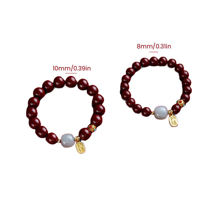 Unisex cinnoberarmband i röd jaspis med släta pärlor, eleganta och jordnära smycken för vardagsbruk.
