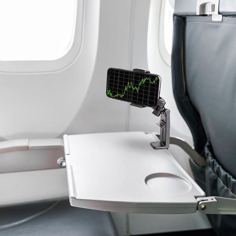 "Universell 360° telefonhållare, kompakt, svart design, monterad på flygplansbricka för resenärer och äventyr."