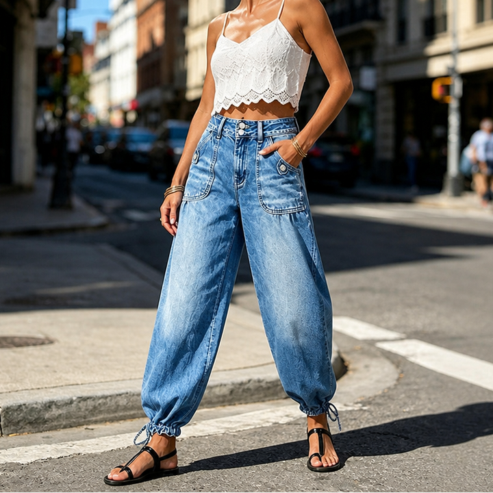 Kvinna i blå barrel-jeans med hög midja och knytband vid anklarna utomhus