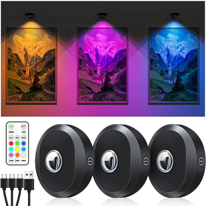 Tre uppladdningsbara RGB LED pucklampor med fjärrkontroll och laddningskablar som lyser upp tavelvägg