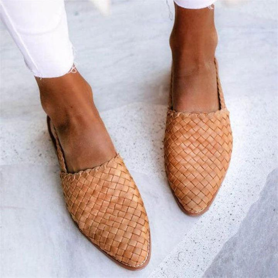 Närbild på ljusbruna flätade slip-on-mules för dam