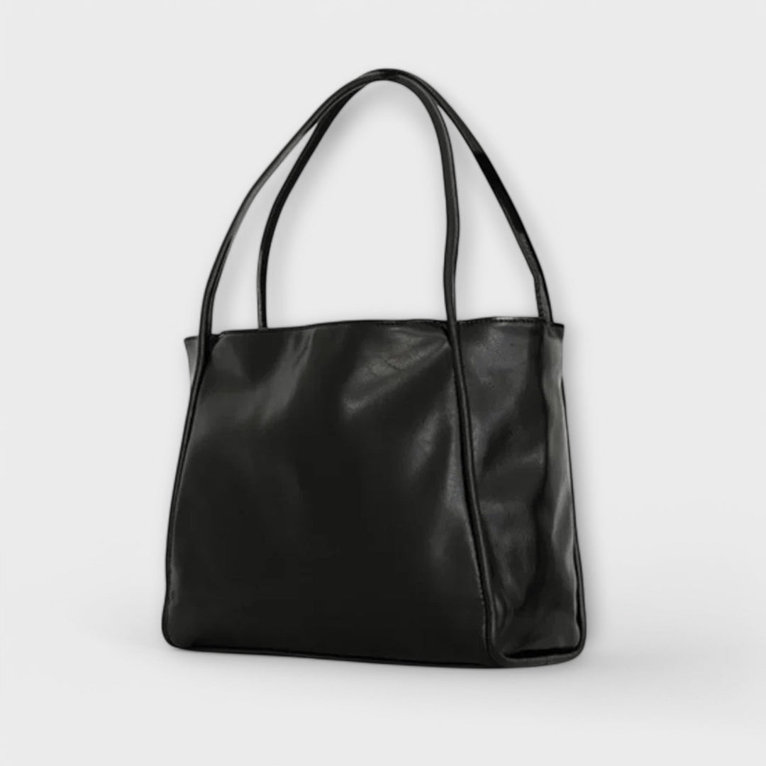 Olivia dam tote-väska i svart från sidan med handtag