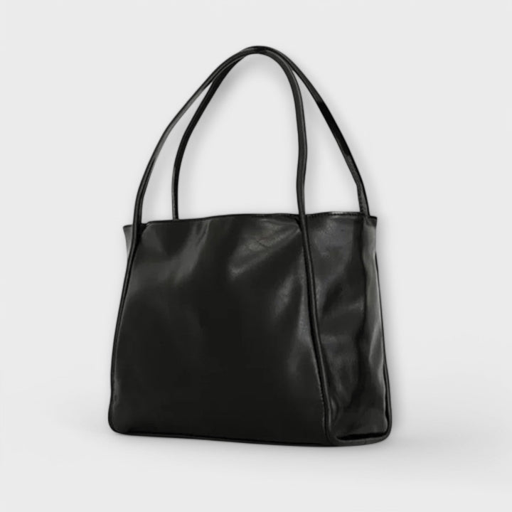 Olivia dam tote-väska i svart från sidan med handtag